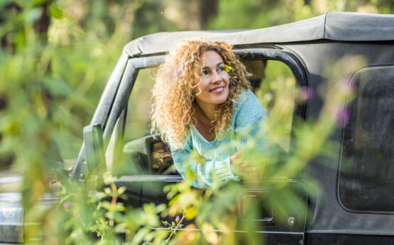 Woman in a Jeep in the Woods