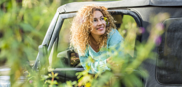 Woman in a Jeep in the Woods